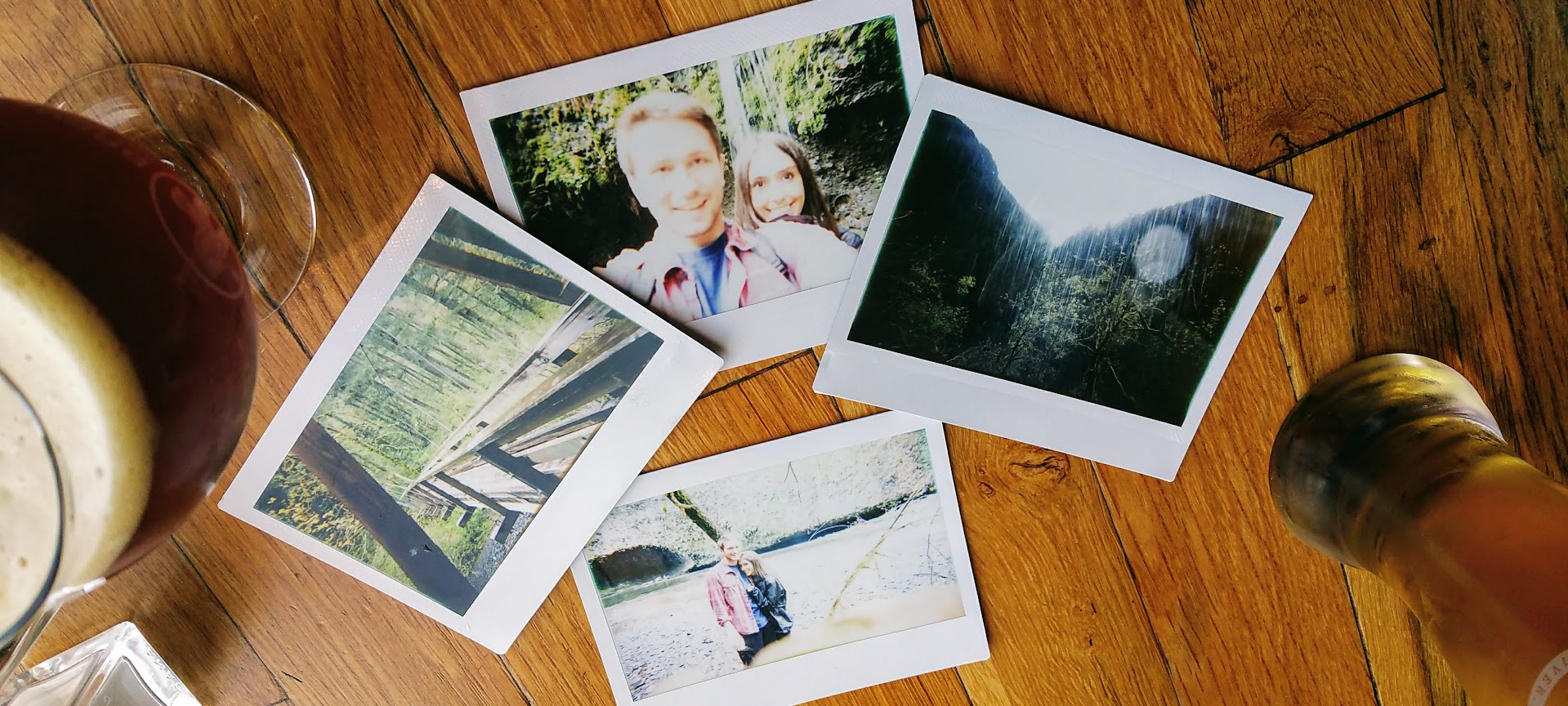 Polaroid snapshots on a wooden table